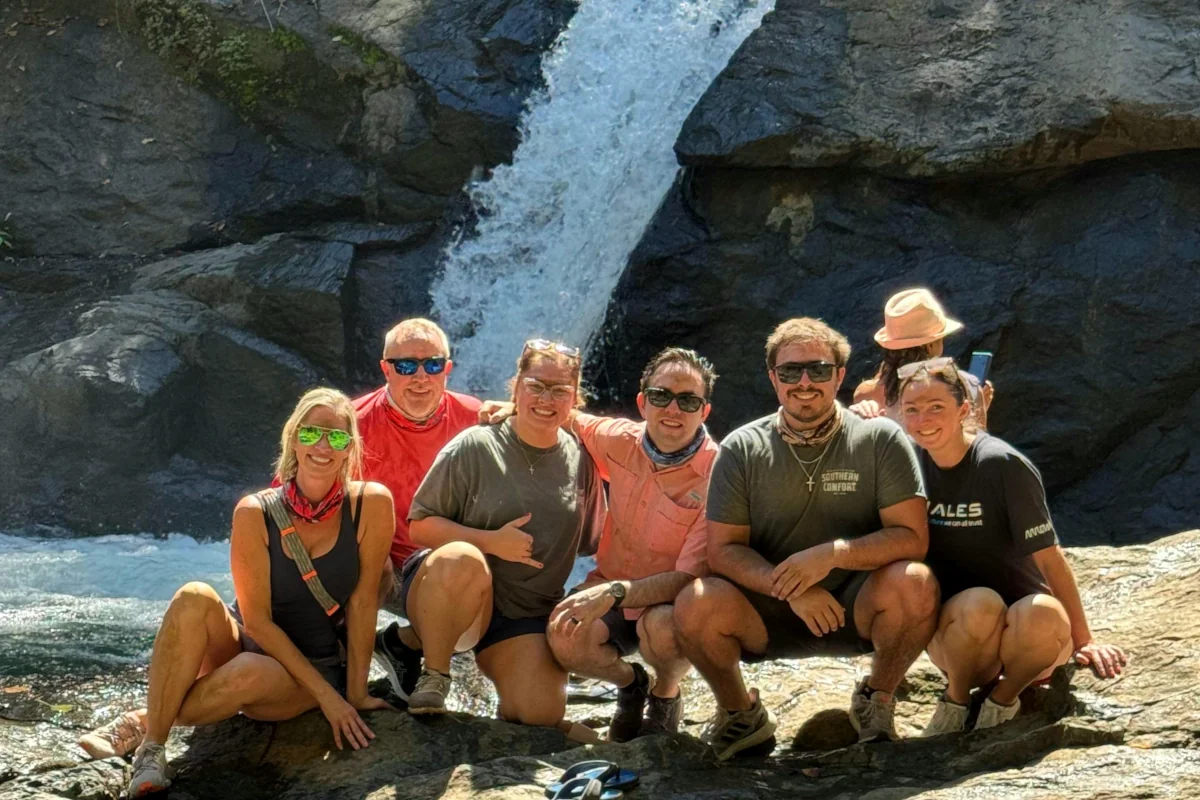 Group of travelers at a waterfall in Guanacaste Costa Rica during an ATV off-road adventure tour