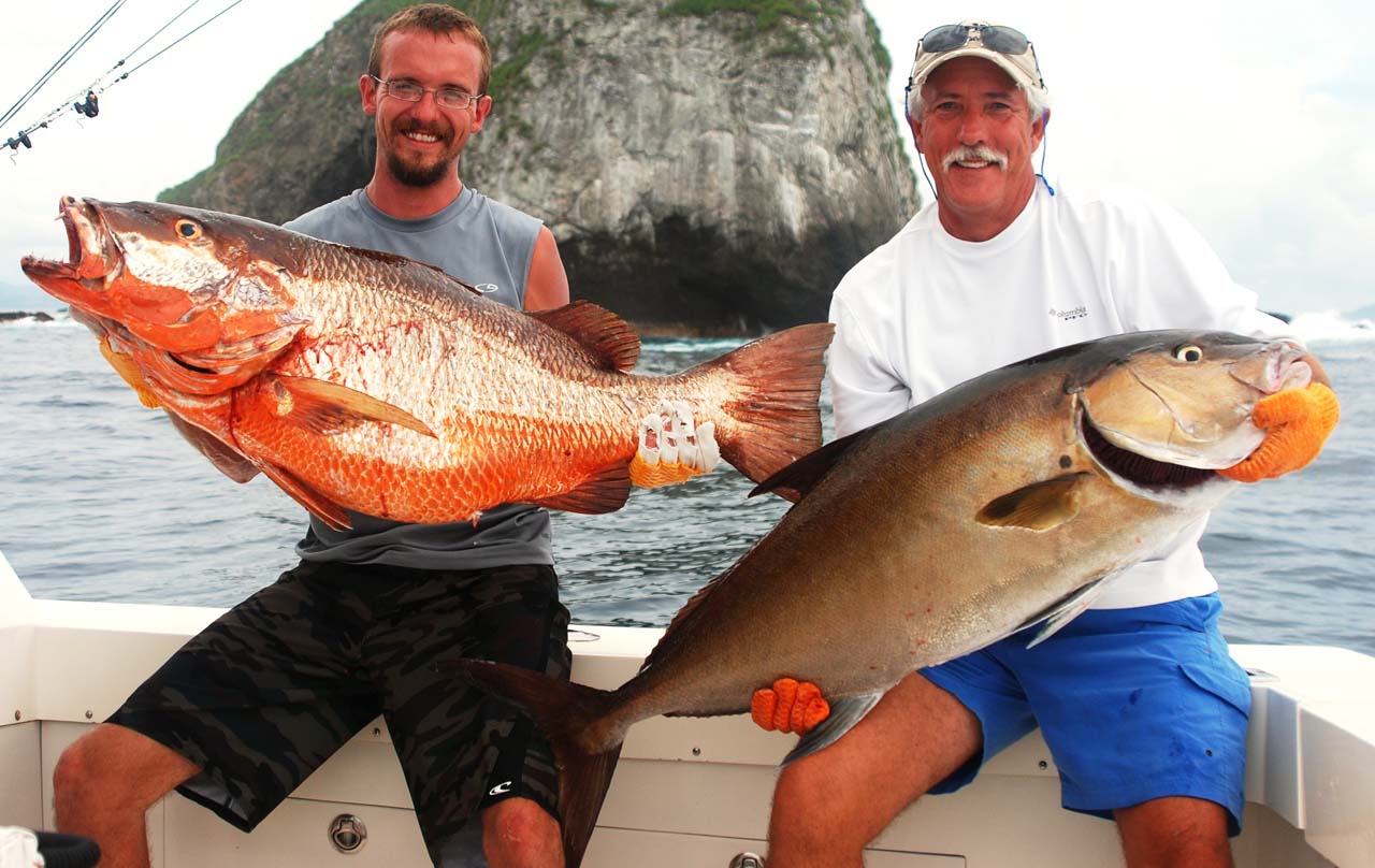 Fisherman holding big red snapper and amberjack in Costa Rica 